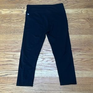 Black crop leggings with star patterned laser cutouts